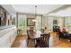 Traditional dining room featuring wainscoting, hardwood floors, and ample natural light at 11259 Calypso Dr, Alpharetta, GA 30009