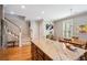 Kitchen featuring center island, hardwood floors, and adjacent staircase at 11259 Calypso Dr, Alpharetta, GA 30009