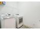 Practical laundry area with modern appliances and overhead storage space at 11259 Calypso Dr, Alpharetta, GA 30009