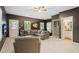 Cozy living room featuring a comfortable sectional sofa, neutral decor, and abundant natural light from the windows at 11259 Calypso Dr, Alpharetta, GA 30009