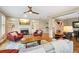 Open-concept living room with hardwood floors, fireplace, and staircase to the upper level at 11259 Calypso Dr, Alpharetta, GA 30009