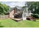 Well-maintained backyard with multiple decks, lush lawn, and mature trees, perfect for outdoor living and entertaining at 1418 Winborn Nw Cir, Kennesaw, GA 30152