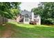 Lush backyard featuring a well-manicured lawn, mature trees, and a fenced perimeter, providing privacy and space at 1418 Winborn Nw Cir, Kennesaw, GA 30152