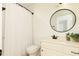 Cozy bathroom with mirror, plant decoration, and shower curtain at 1418 Winborn Nw Cir, Kennesaw, GA 30152