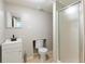 Bathroom with a modern toilet, sink, vanity, and stand up shower with glass doors at 1418 Winborn Nw Cir, Kennesaw, GA 30152