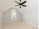 Upstairs bedroom with vaulted ceiling, arched window, and neutral carpet at 1418 Winborn Nw Cir, Kennesaw, GA 30152