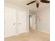 Neutral bedroom with two doors, ceiling fan, view of bathroom, and neutral carpet at 1418 Winborn Nw Cir, Kennesaw, GA 30152