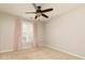 Neutral bedroom with window and pink curtains, ceiling fan, and neutral carpet at 1418 Winborn Nw Cir, Kennesaw, GA 30152