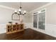 Formal dining room with hardwood floors, crown molding and a modern chandelier at 1418 Winborn Nw Cir, Kennesaw, GA 30152