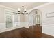 Bright dining room with hardwood floors, classic wainscoting and updated lighting at 1418 Winborn Nw Cir, Kennesaw, GA 30152