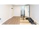 Bright workout room with gray wood floors, weight training equipment and access to additional rooms at 1418 Winborn Nw Cir, Kennesaw, GA 30152