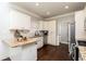 Well-appointed kitchen with granite countertops, stainless steel appliances, and white cabinetry at 1418 Winborn Nw Cir, Kennesaw, GA 30152
