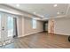 Large room with gray wood floors, access to a bathroom and a glass door to the exterior at 1418 Winborn Nw Cir, Kennesaw, GA 30152