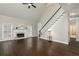 Inviting living room with soaring ceilings, fireplace and staircase with dark hardwood flooring at 1418 Winborn Nw Cir, Kennesaw, GA 30152