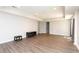 Empty, bright room with gray wood floors, recessed lighting, and access to additional rooms at 1418 Winborn Nw Cir, Kennesaw, GA 30152