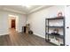 Bright room with modern gray wood floors, storage shelving, and small wine storage rack near doorway at 1418 Winborn Nw Cir, Kennesaw, GA 30152