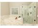 Gorgeous bathroom with a large tub, glass shower, and mosaic tile at 1418 Winborn Nw Cir, Kennesaw, GA 30152