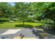 Picturesque backyard featuring a hammock and outdoor dining set on a lush lawn shaded by mature trees at 2296 N Shallowford Rd, Atlanta, GA 30341