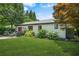 Well-maintained backyard featuring a lush lawn, complemented by a deck, grill, and decorative landscaping at 2296 N Shallowford Rd, Atlanta, GA 30341