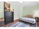 Cozy bedroom with light green walls, a black dresser, and minimalist bed frame, illuminated by table lamps at 2296 N Shallowford Rd, Atlanta, GA 30341