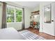 Bedroom showcasing a desk area with shelves, complemented by light walls, hardwood floors, and patterned curtains at 2296 N Shallowford Rd, Atlanta, GA 30341
