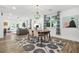 Bright dining room with stylish chandelier, a decorative rug and many windows at 2296 N Shallowford Rd, Atlanta, GA 30341