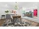 Dining room with modern lighting, hardwood floors, and an open view to the adjacent kitchen at 2296 N Shallowford Rd, Atlanta, GA 30341