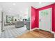 Open-concept entryway showcasing a modern kitchen, dining area, and vibrant accent wall at 2296 N Shallowford Rd, Atlanta, GA 30341