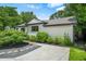 Exterior view of home showing concrete driveway, white siding, brown trim and manicured landscaping at 2296 N Shallowford Rd, Atlanta, GA 30341