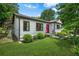 Charming one-story home with white siding, black trim, lush lawn and a bright pink front door at 2296 N Shallowford Rd, Atlanta, GA 30341