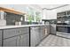 Well-lit kitchen featuring quartz countertops, stainless steel appliances, and decorative backsplash at 2296 N Shallowford Rd, Atlanta, GA 30341