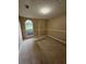 A carpeted bedroom features a large window offering ample natural light, neutral walls, and unique textured ceiling at 3502 Tiffany Se Dr, Conyers, GA 30013
