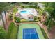 Aerial view of community pool, clubhouse, and tennis court with lush green landscaping at 3702 Running Fox Dr, Marietta, GA 30062