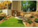 Backyard patio with outdoor seating, steps up to the lawn, and lush landscaping at 3702 Running Fox Dr, Marietta, GA 30062
