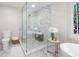 Elegant bathroom featuring a glass enclosed shower with marble tile and decorative accents at 3702 Running Fox Dr, Marietta, GA 30062