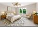 Inviting bedroom with neutral colors, a ceiling fan, and a large window for ample natural light at 3702 Running Fox Dr, Marietta, GA 30062