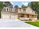 Charming two-story home with a welcoming front porch and a spacious three-car garage at 3702 Running Fox Dr, Marietta, GA 30062