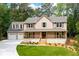 Charming two-story home with a welcoming front porch and a spacious three-car garage at 3702 Running Fox Dr, Marietta, GA 30062