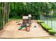 Community playground with a slide, swings, and climbing structure surrounded by trees at 3702 Running Fox Dr, Marietta, GA 30062