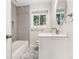 Updated bathroom with subway tile shower, marble floors, and modern vanity with lighting at 46 Cooper Lake Sw Rd, Mableton, GA 30126