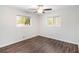 Bright bedroom featuring hardwood floors, a ceiling fan, and two large windows at 46 Cooper Lake Sw Rd, Mableton, GA 30126