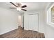 Well-lit bedroom with new flooring, closet, fan, and a view to the outside at 46 Cooper Lake Sw Rd, Mableton, GA 30126