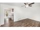 Open-concept room with wood floors, ceiling fan and kitchen view at 46 Cooper Lake Sw Rd, Mableton, GA 30126
