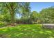 Large, grassy backyard with mature trees, offering a serene and private outdoor space at 739 Pinehill Se Dr, Smyrna, GA 30080