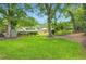 Spacious backyard featuring a large lawn, mature trees, and a view of the houses at 739 Pinehill Se Dr, Smyrna, GA 30080