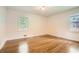 Well-lit bedroom featuring beautiful hardwood floors and two windows at 739 Pinehill Se Dr, Smyrna, GA 30080