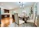 Stylishly staged dining room with a table setting and hardwood floors, connected to an updated kitchen at 739 Pinehill Se Dr, Smyrna, GA 30080