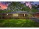 Charming brick home with green shutters and a well-manicured front lawn at 739 Pinehill Se Dr, Smyrna, GA 30080