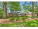 Single story brick home with large mature trees and manicured landscaping at 739 Pinehill Se Dr, Smyrna, GA 30080