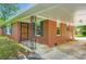 Inviting brick home showcasing a covered front porch with wrought iron details and a beautiful wood front door at 739 Pinehill Se Dr, Smyrna, GA 30080